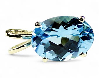 May include: A gold pendant featuring a large oval-shaped blue topaz gemstone.
