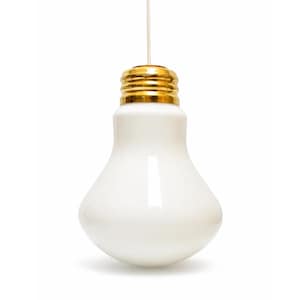 May include: A white ceramic light bulb pendant lamp with a gold-colored base. The light bulb is hanging from a thin white cord against a white background. The lamp is a decorative lighting fixture.