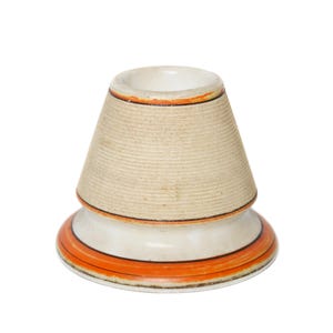 May include: A ceramic candle holder with a cream-colored, textured cone-shaped top and a white base. The base is decorated with orange and black stripes. The rim of the top is also trimmed with orange.