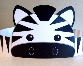 May include: A black and white zebra head paper crown with black eyes and a black nose. The crown is decorated with a black and white striped pattern.