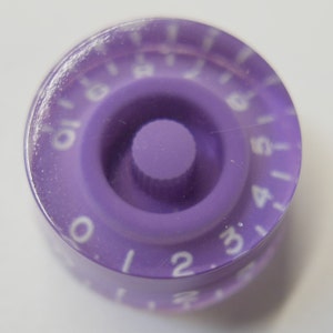 May include: Purple guitar knob with white numbers 0-5.