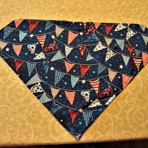 May include: A blue bandana with a red, white, and blue bunting pattern. The bunting is made up of small triangles with stars and polka dots.