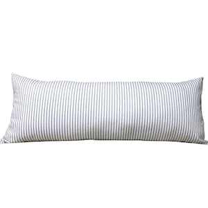 May include: A white and gray striped lumbar pillow. The pillow is rectangular and has a soft, plush feel.