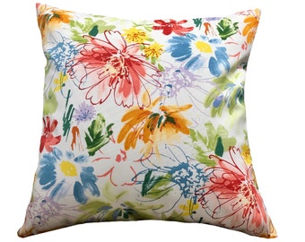 May include: A white pillow with a floral pattern. The flowers are in shades of pink, orange, yellow, and blue. The pillow is made of a soft, comfortable fabric.