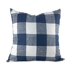 May include: A navy blue and white checkered throw pillow. The pillow is made of a soft, textured fabric.