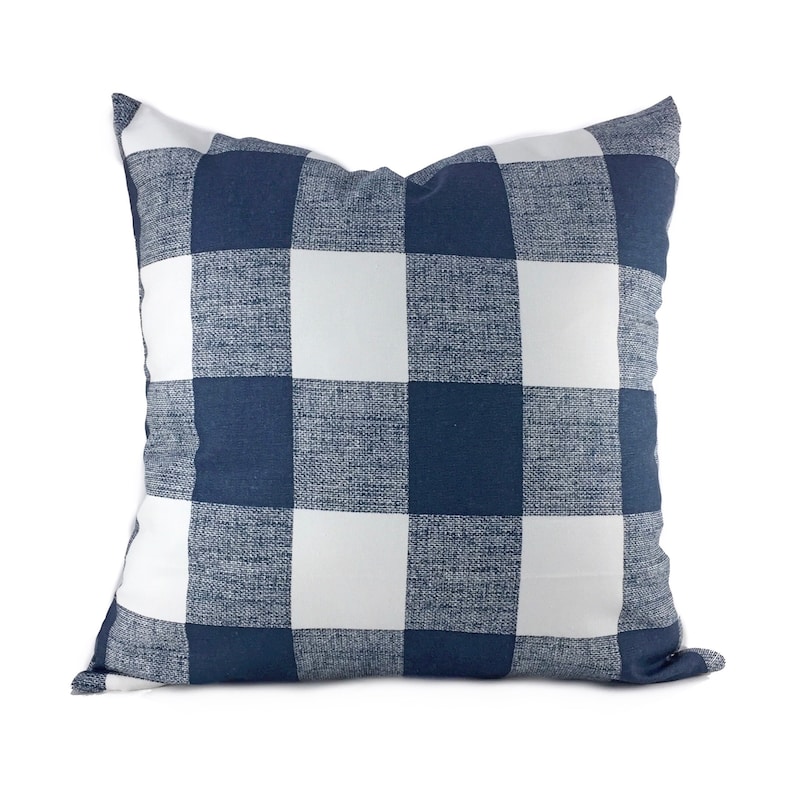 May include: A navy blue and white checkered throw pillow. The pillow is made of a soft, textured fabric.