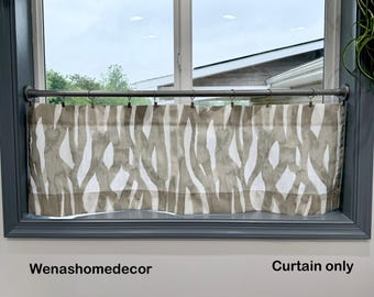 May include: A window curtain with a neutral color palette. The curtain features a pattern of vertical, abstract shapes in shades of brown and white. The curtain is hung on a metal rod above a window. The text "Curtain only" is visible.