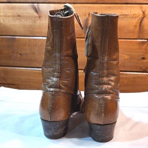 back side image of a pair of brown leather Victorian style boots with medium heels and tan laced fronts
