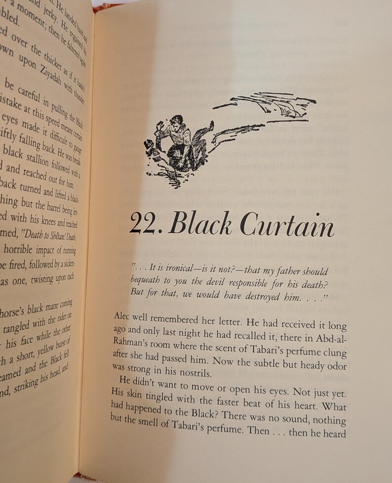 An open book page with text and an illustration. The illustration depicts a person on a horse. The text reads "22. Black Curtain". The page has a cream-colored background.