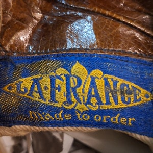A label inside a pair of ladies brown leather Victorian lace up boots. The label is blue and gold and reads LA FRANCE Made to Order