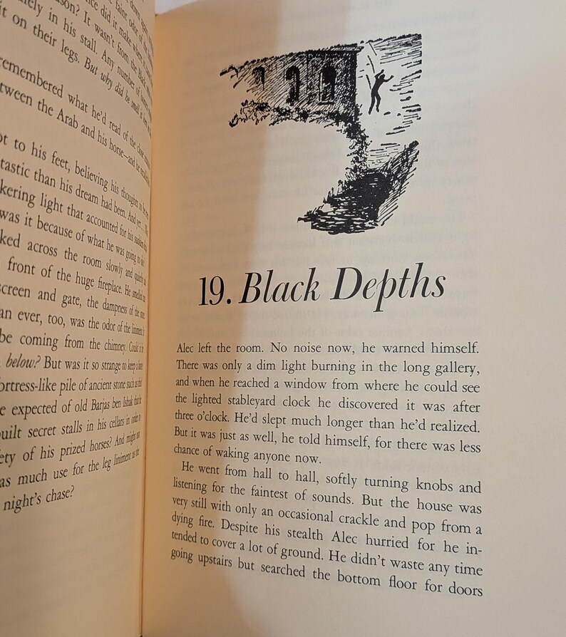 An open book page with text and a black and white illustration. The illustration depicts a building with a figure in front. The text reads "19. Black Depths". The page has a cream color.
