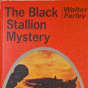 Cover of a book titled The Black Stallion Mystery by Walter Farley. The cove ris orange with a grey-trimmed oval silhouette picture of a boy riding a horse with a long mane