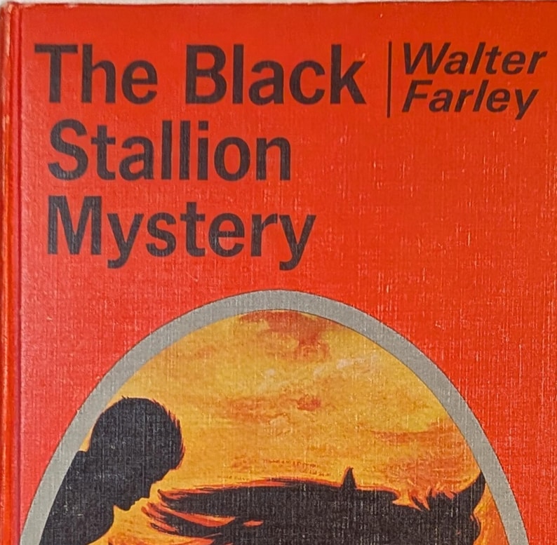 Cover of a book titled The Black Stallion Mystery by Walter Farley. The cove ris orange with a grey-trimmed oval silhouette picture of a boy riding a horse with a long mane
