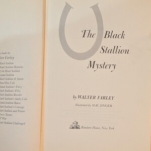 Title page for a book with the title "The Black Stallion Mystery" with a horseshoe graphic. The author is Walter Farley, illustrated by Mal Singer. Published by Random House, New York.