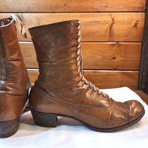 Right side image of a pair of ladies brown leather Victorian short boots with tan laced fronts. The boots have a medium heel and low-calf height.