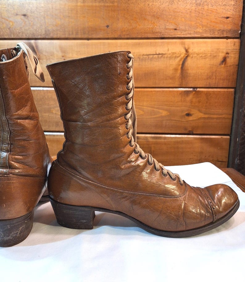 Right side image of a pair of ladies brown leather Victorian short boots with tan laced fronts. The boots have a medium heel and low-calf height.