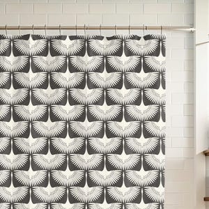 May include: A black and white shower curtain with a repeating pattern of stylised bird wings.