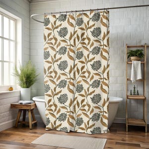 May include: A beige shower curtain with a repeating pattern of black and brown floral elements. The design features stylized flowers and leaves on a cream background. The curtain is hanging in a bathroom setting.