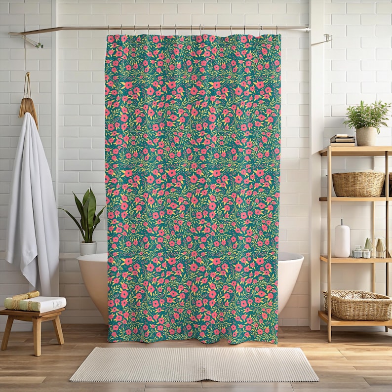 May include: A teal shower curtain with a repeating floral pattern. The design features pink flowers and green leaves. The curtain is hanging in a bathroom setting, adding a touch of nature to the space.