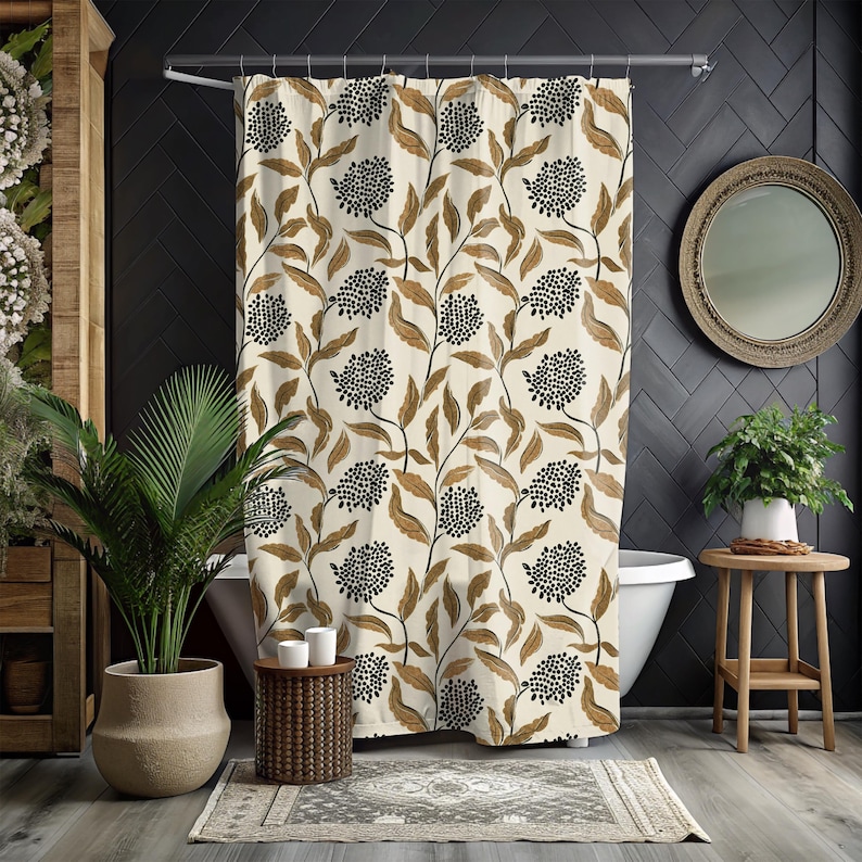 May include: Cream-colored shower curtain with a repeating pattern of black floral clusters and brown leaves. The curtain hangs in a bathroom with a white bathtub, plants, and a round mirror. The overall theme is botanical.