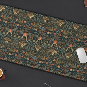 May include: A dark blue mouse pad with a repeating pattern of stylized birds, flowers, and leaves. The pattern is in shades of orange, brown, and green.