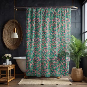 May include: A teal shower curtain with a repeating floral pattern of pink flowers and green leaves. The curtain hangs in front of a white bathtub, with a wooden side table and a potted plant visible in the bathroom.