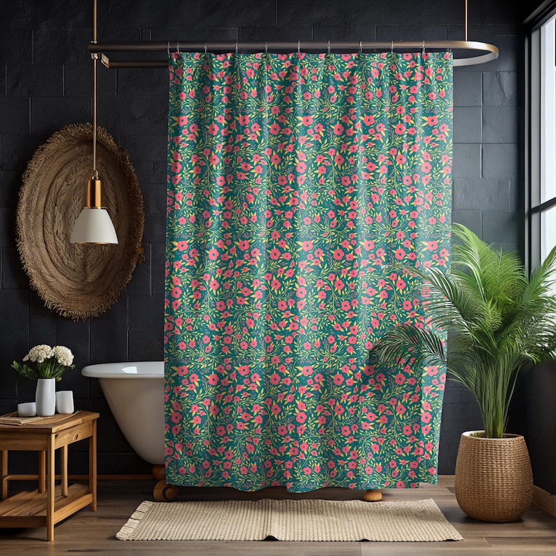 May include: A teal shower curtain with a repeating floral pattern of pink flowers and green leaves. The curtain hangs in front of a white bathtub, with a wooden side table and a potted plant visible in the bathroom.