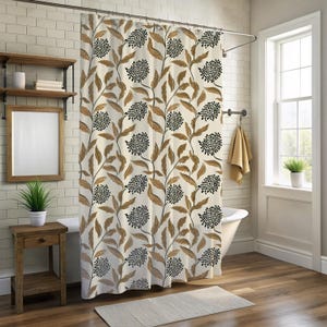 May include: A floral shower curtain with a cream background and a pattern of brown leaves and black flower clusters. The curtain hangs in a bathroom with a white tub, wooden side table, and a window.