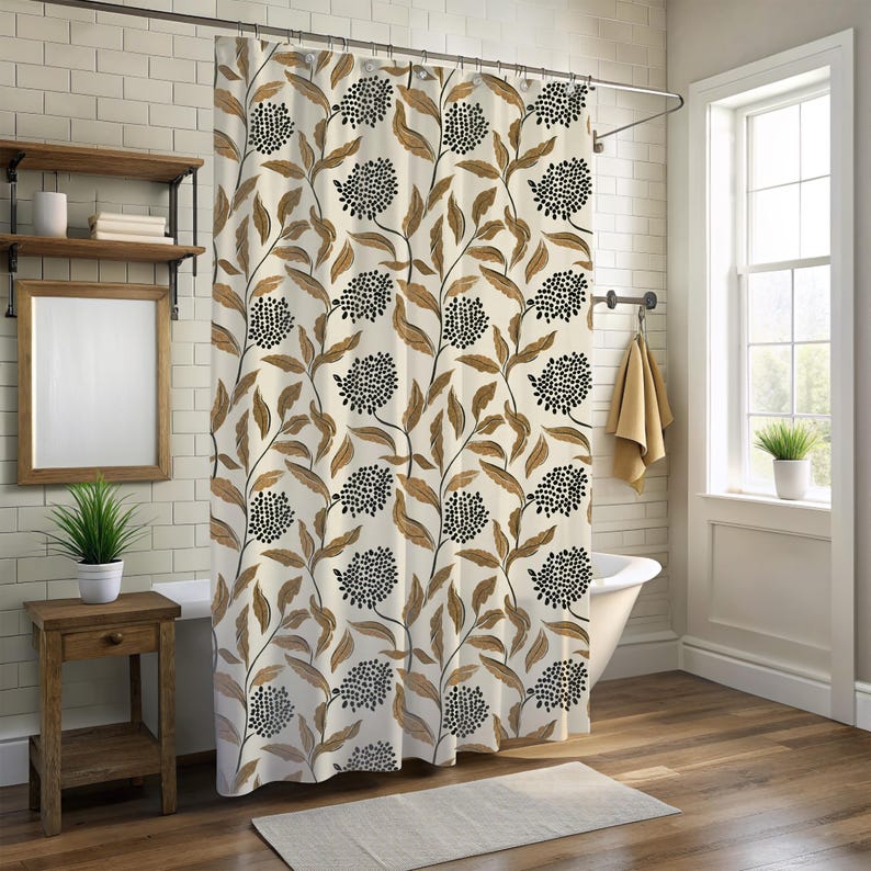 May include: A floral shower curtain with a cream background and a pattern of brown leaves and black flower clusters. The curtain hangs in a bathroom with a white tub, wooden side table, and a window.