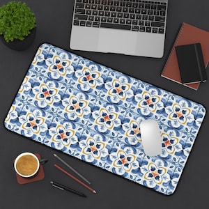 May include: A rectangular mouse pad with a blue, white, and yellow floral pattern. The pad has a black border and is shown with a white mouse, laptop, and office supplies.