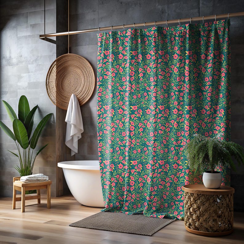 May include: A teal shower curtain with a repeating floral pattern of pink flowers and green leaves. The curtain hangs in front of a white bathtub, with a wooden stool and a potted plant visible.