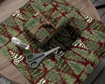 May include: Red wrapping paper with a repeating pattern of green pine trees. A brown gift box with a brown ribbon is on top of the wrapping paper. A pair of scissors and a roll of tape are also on the wrapping paper.