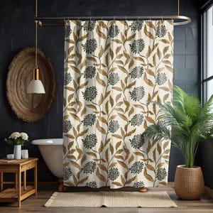 May include: A beige shower curtain with a repeating pattern of brown leaves and black floral clusters. The curtain hangs in front of a white bathtub, with a wooden side table and a potted plant visible.