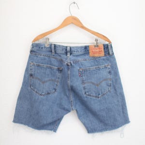 May include: A set of three ceramic vases in varying heights and shapes. The vases are glazed in a matte white finish, offering a minimalist aesthetic. The tallest vase is approximately 10 inches high.