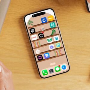 May include: A smartphone screen displaying a bookshelf with various app icons, including "Care", "Stop Me", and "Camo".