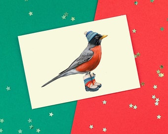 Carte d'oiseau de noël, carte de souhaits de Merle d'Amérique en bottes d'hiver avec une tuque, carte de noël