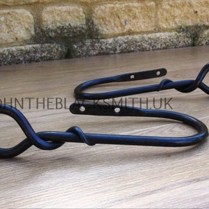 A Pair of Blacksmith made Wrought Iron Forged Mouse Tail Curtain Holdbacks / Tie backs, forged in the UK