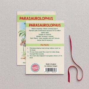Parasaurolophus A6 dinosaur fact card beside a burgundy hanging ribbon, with readable facts about its crest, Late Cretaceous period, plant diet and North American home.