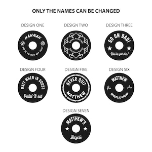 Personalised black aluminium bike headset cap design choices labelled one to seven, including names, cycling messages, stars, flowers and a bicycle chain border. Only names can be changed.