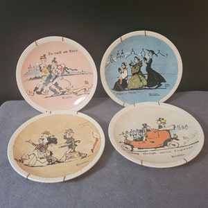 May include: Set of four decorative plates with illustrations and text. The plates are white with a cream colored rim and a white border. The plates feature illustrations of people in different settings. The text on the plates includes "Die walk am Rhein", "When in Rome", "Promenade a Paris", and "Walking through metric England".