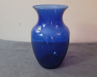 May include: A cobalt blue glass vase with a rounded body and a narrow neck.