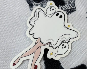 May include: A white ghost sticker with a pair of legs and red high heels. The ghost is wearing a witch's hat and has a small ghost on its shoulder. The sticker is on a white background with a skull design.