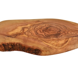 May include: A natural wood serving board with a unique, organic shape and a beautiful grain pattern. The board is made of olive wood and has a rich, warm brown colour.