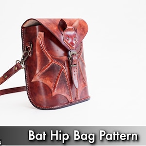 May include: A digital PDF download for a bat hip bag pattern featuring a brown leather bag with a bat-shaped flap, embossed wing details, a buckle closure, and an adjustable shoulder strap. The text reads PDF DOWNLOAD and BAT HIP BAG PATTERN.