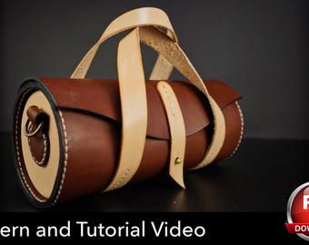May include: A cylindrical brown leather bag with light beige leather straps and trim. The bag features a metal D-ring on the side and a central strap closure with a metal stud. The text "Pattern and Tutorial Video" and a red "PDF DOWNLOAD" icon appear.