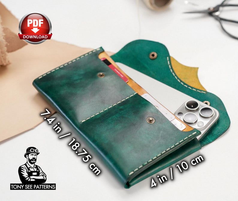 May include: A handcrafted, green leather phone case with white stitching. The case, measuring 7.4 inches by 4 inches, features a snap closure and holds a smartphone and cards. The design includes a unique flap and the text "TONY SEE PATTERNS".