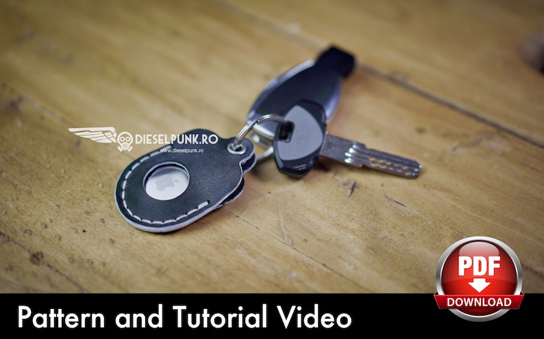May include: A black leather key fob with a white stitch detail and a round cutout. The fob is attached to a silver key ring with a silver key. The key fob is on a wooden surface.  Pattern and Tutorial Video. PDF Download.