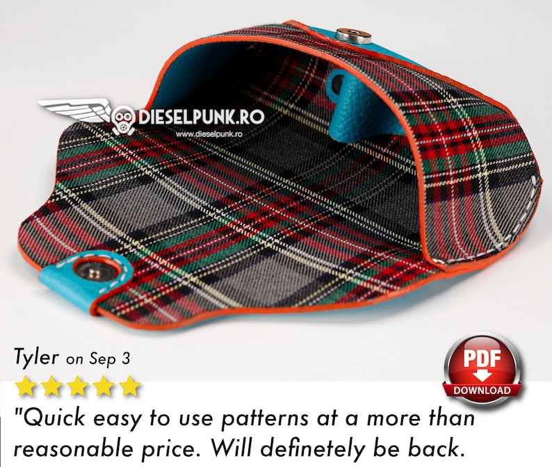 May include: A red, green, and black plaid fabric wallet with a blue lining and orange stitching. The wallet is open and the inside is visible. The wallet is made of leather and has a snap closure.