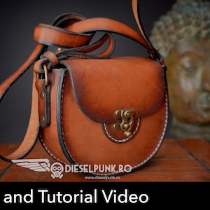 May include: A brown leather crossbody bag with a curved design and a brass clasp. The bag has a long strap and white stitching. The image also includes the text "Pattern and Tutorial Video".