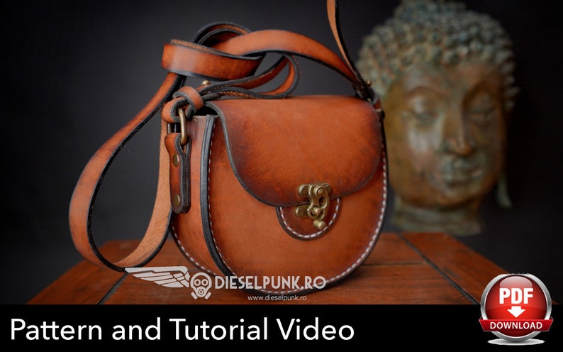 May include: A brown leather crossbody bag with a curved design and a brass clasp. The bag has a long strap and white stitching. The image also includes the text "Pattern and Tutorial Video".